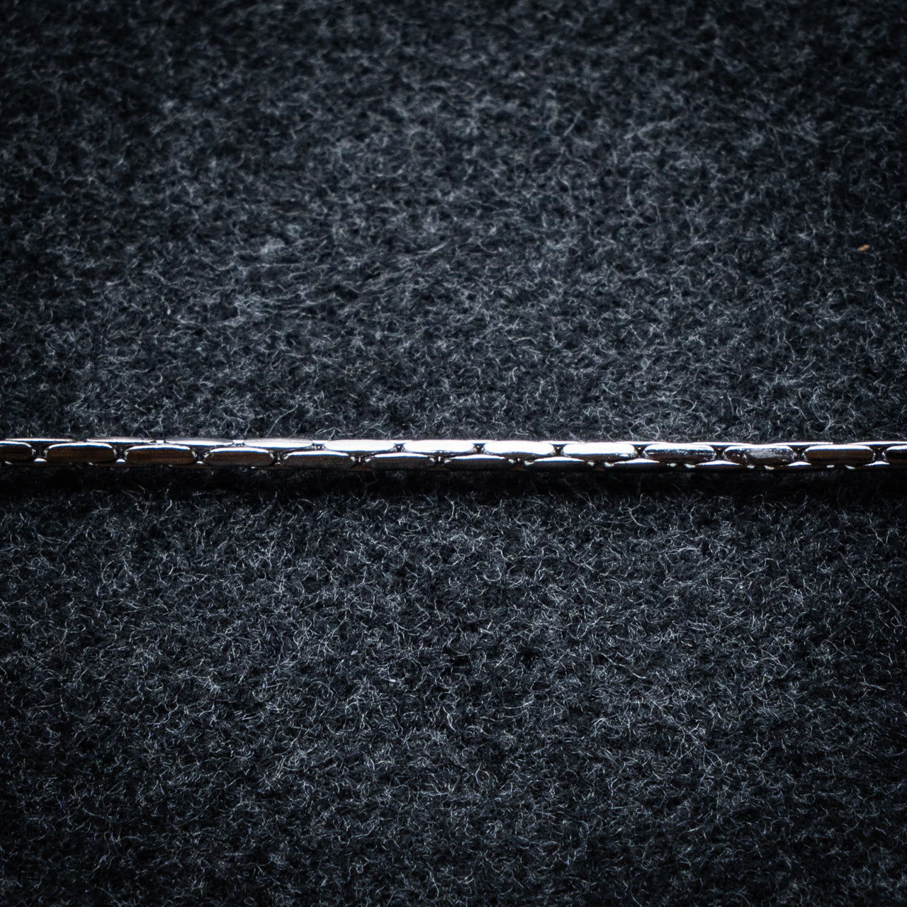 Close-up of a textured dark surface with a horizontal line running through it
